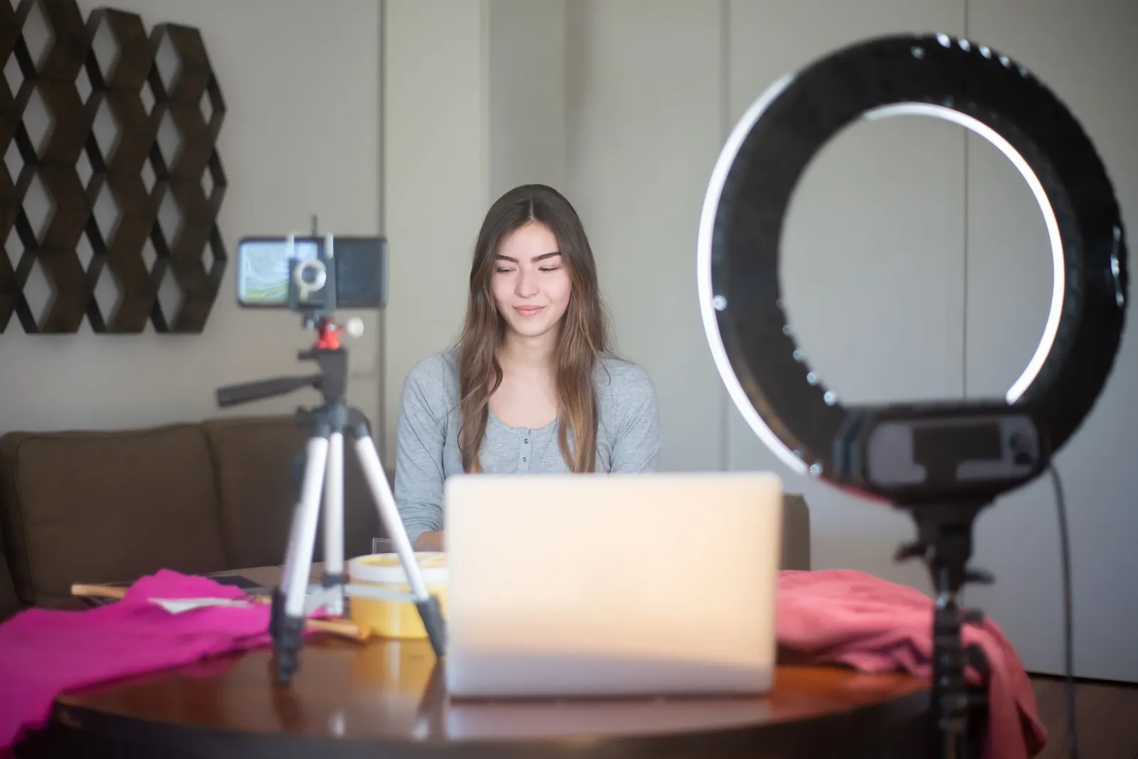 A person filming with a phone mounted on a tripod